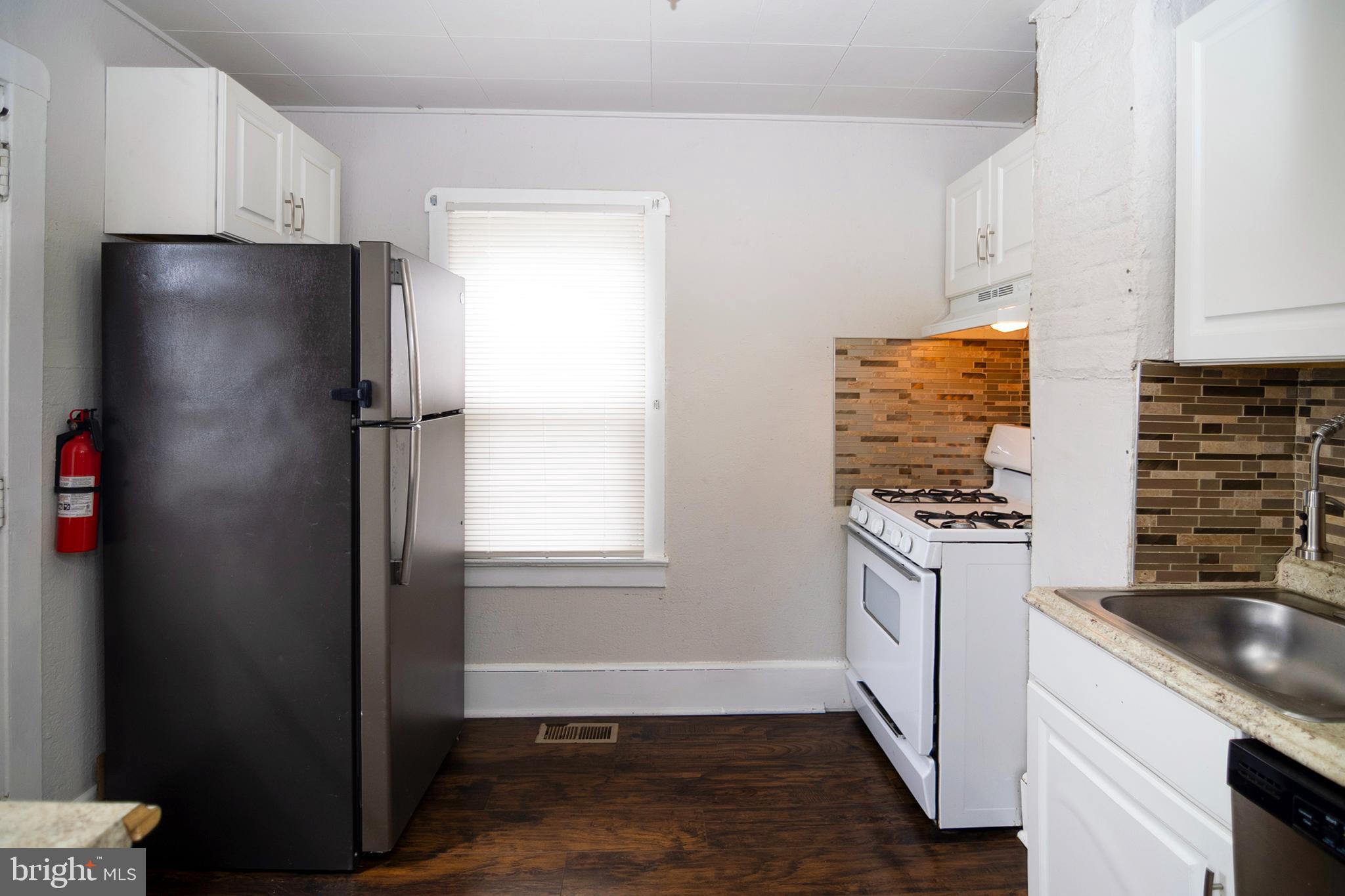 211 Chestnut Street Glendora, NJ 08029 - Photo 10 of 34 a kitchen with a refrigerator and a sink