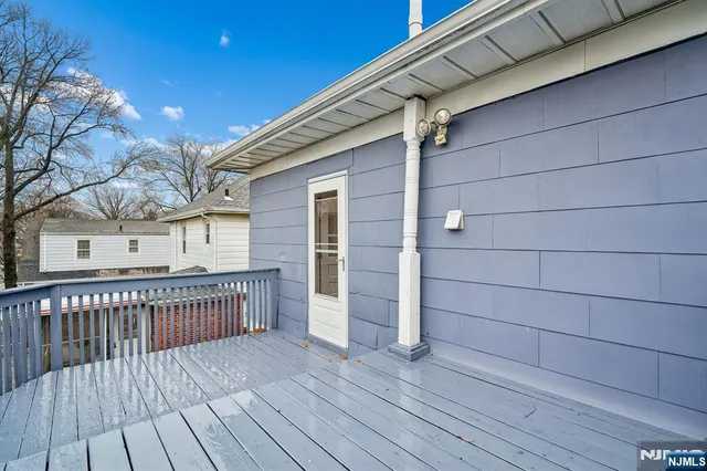 a view of a house with a wooden deck