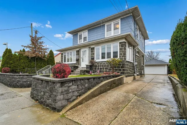 a front view of a house with yard and sitting area