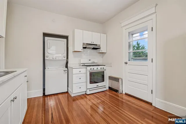a kitchen with wooden floors and appliances