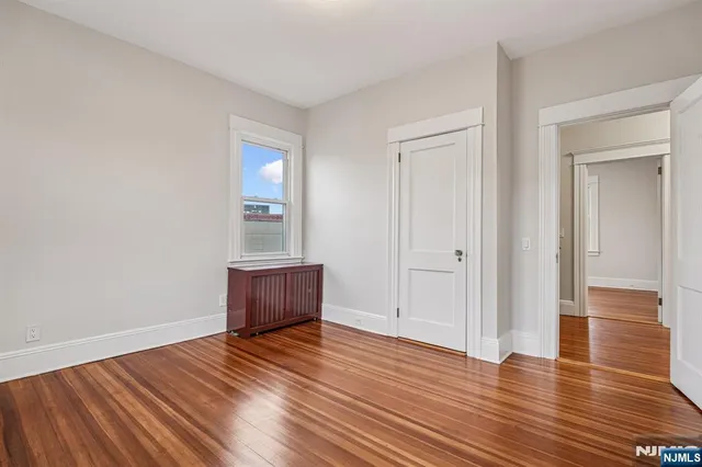 a view of an empty room and wooden floor