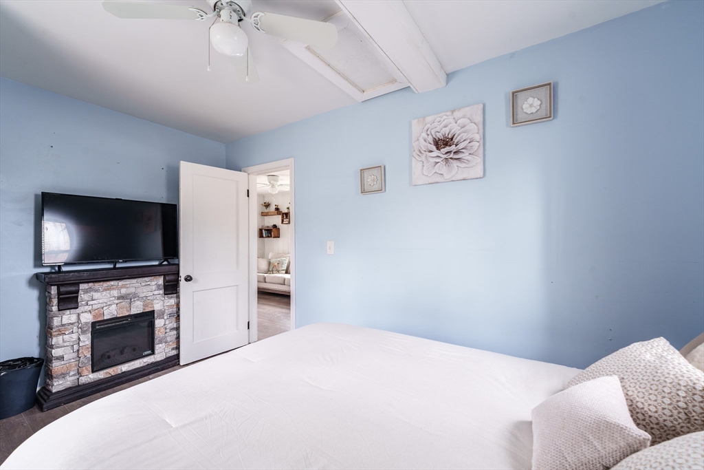 15 Sichols Colony Road Wales, MA 01081 - Photo 23 of 31 a bedroom with a bed and a flat screen tv