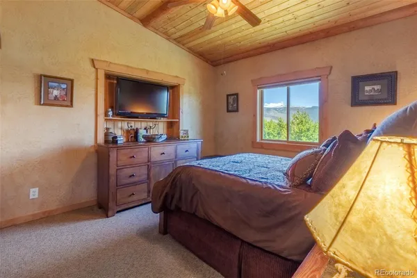a bedroom with a bed and a television