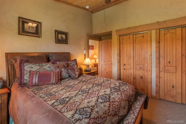 a bedroom with a large bed and a dresser