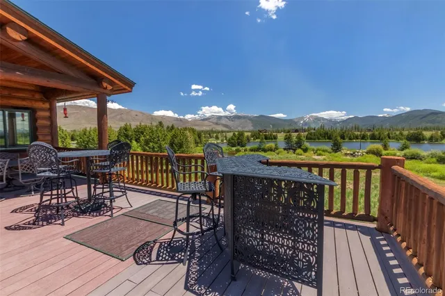 a view of a balcony with wooden floor and outdoor seating
