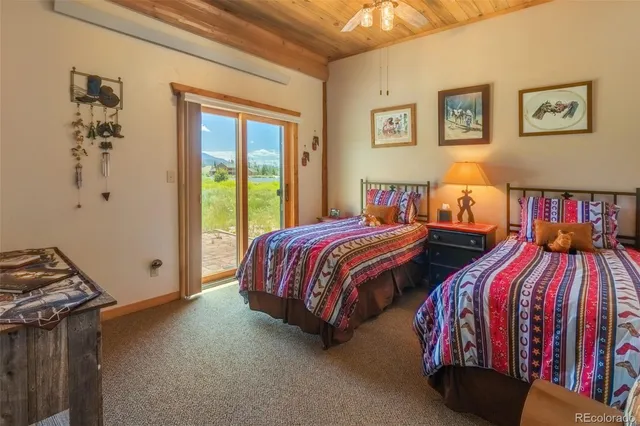 a bedroom with two beds and a window