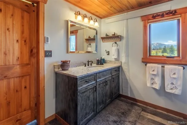a bathroom with a sink a mirror and a shower