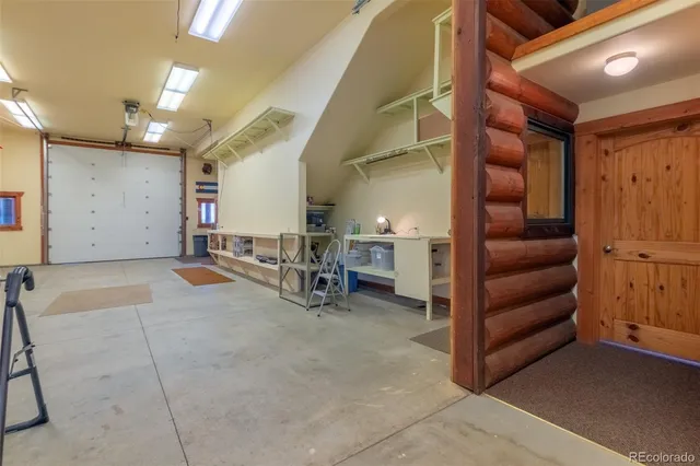 a living room with furniture and a workspace