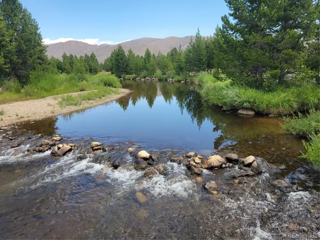 an aerial view of a house with a lake view