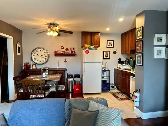 a view of a kitchen with fridge and workspace