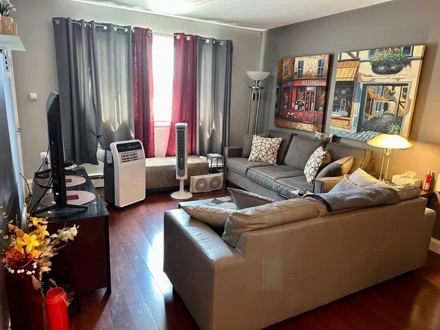 a living room with furniture and a large window