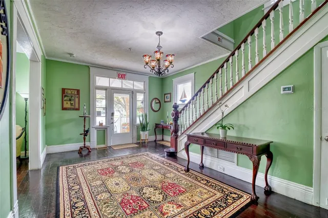 a view of living room with furniture and wooden floor