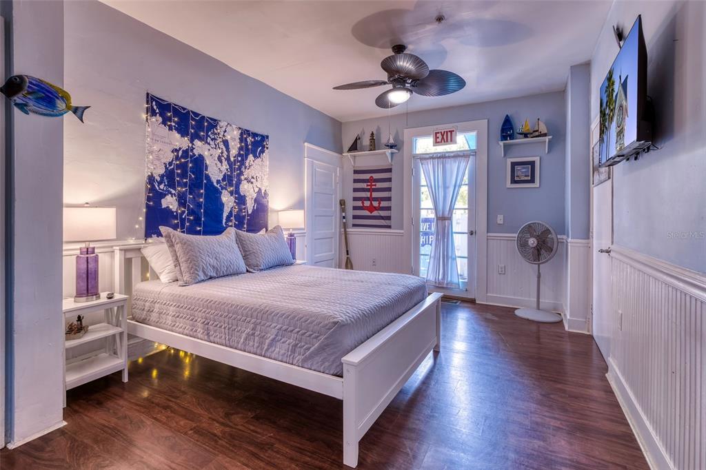 304 15th Street West Bradenton, FL 34205 - Photo 21 of 75 a bedroom with a bed and a chandelier