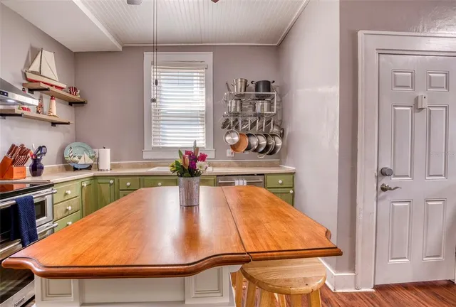 a view of entryway and workspace with wooden floor