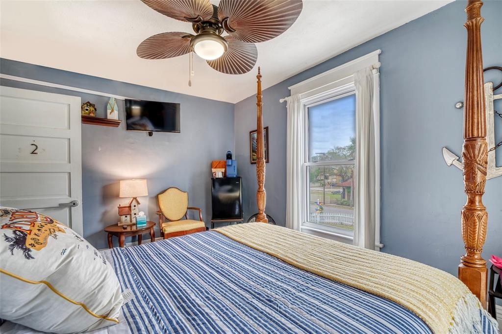 304 15th Street West Bradenton, FL 34205 - Photo 34 of 75 a bedroom with a bed and a chandelier