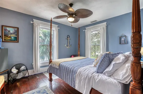 a living room with furniture and a painting on the wall