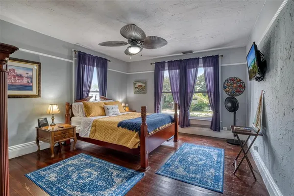 a living room with furniture a chandelier and a flat screen tv