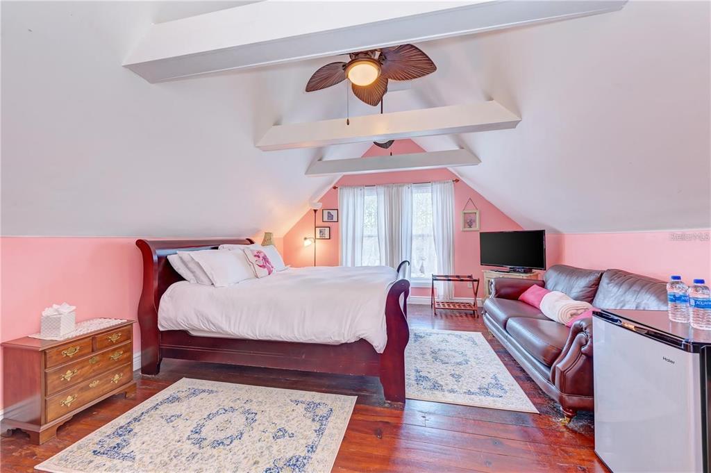 304 15th Street West Bradenton, FL 34205 - Photo 49 of 75 a bed room with a bed and a chandelier