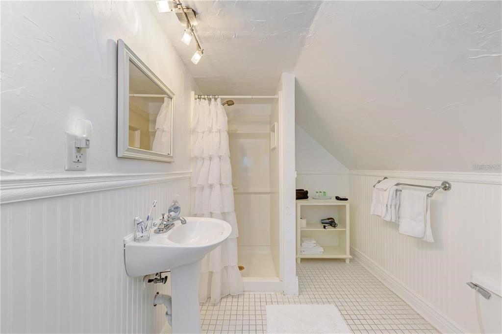 304 15th Street West Bradenton, FL 34205 - Photo 50 of 75 a bathroom with a sink a mirror and a shower