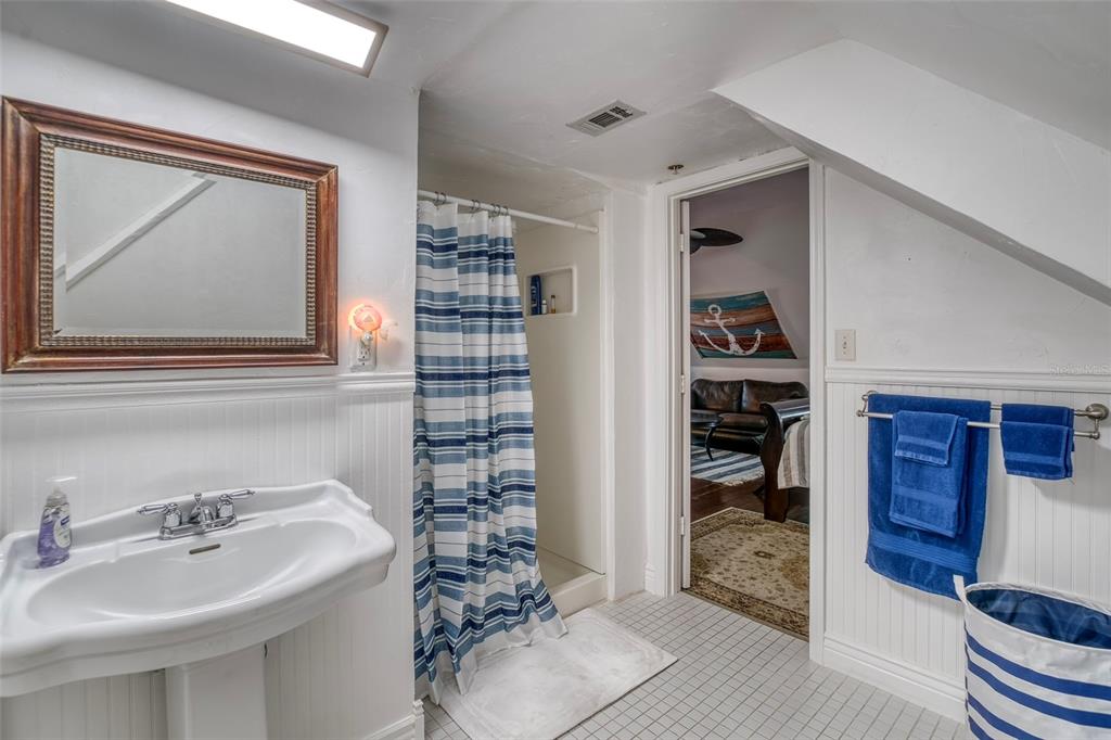 304 15th Street West Bradenton, FL 34205 - Photo 55 of 75 a bathroom with a sink a mirror and shower