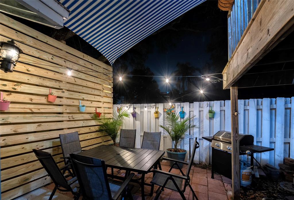 304 15th Street West Bradenton, FL 34205 - Photo 57 of 75 a view of a patio with table and chairs with potted plants