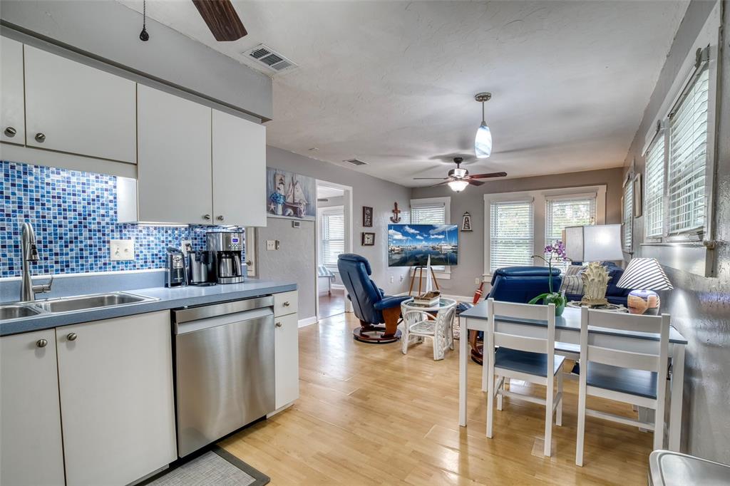 304 15th Street West Bradenton, FL 34205 - Photo 61 of 75 a kitchen with stainless steel appliances kitchen island granite countertop a table chairs sink and cabinets