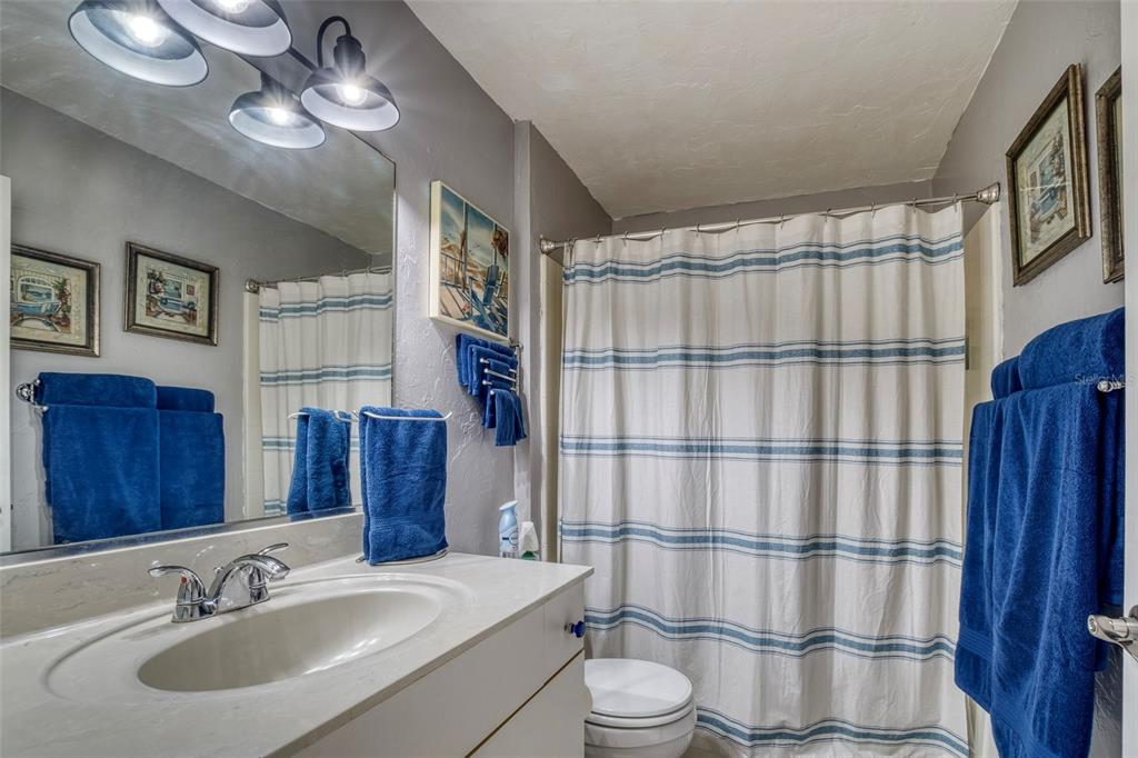 304 15th Street West Bradenton, FL 34205 - Photo 67 of 75 a bathroom with a sink toilet a mirror and shower