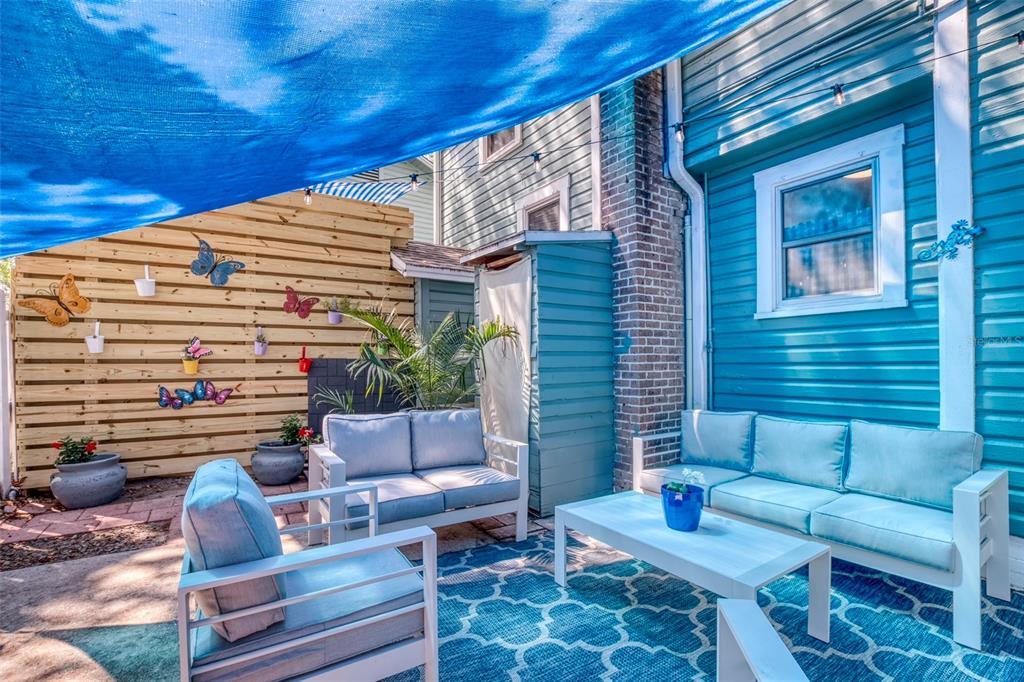 304 15th Street West Bradenton, FL 34205 - Photo 73 of 75 a outdoor space with patio the couches and a potted plant on a table
