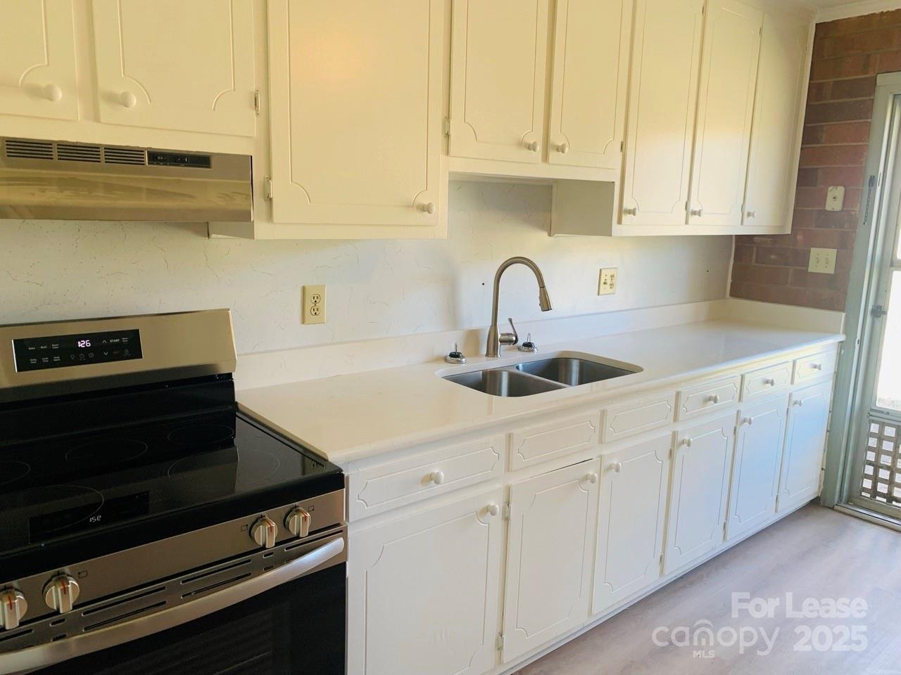 8544 Babe Drive Terrell, NC 28682 - Photo 4 of 20 a kitchen with white cabinets and appliances