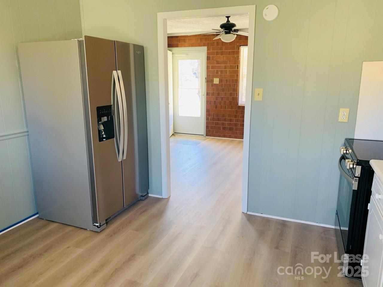 8544 Babe Drive Terrell, NC 28682 - Photo 6 of 20 a view of a refrigerator in kitchen and wooden floor