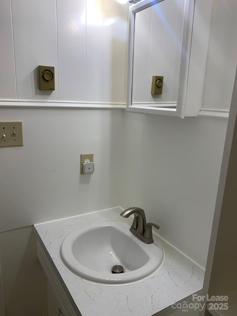 8544 Babe Drive Terrell, NC 28682 - Photo 8 of 20 a bathroom with a sink and mirror