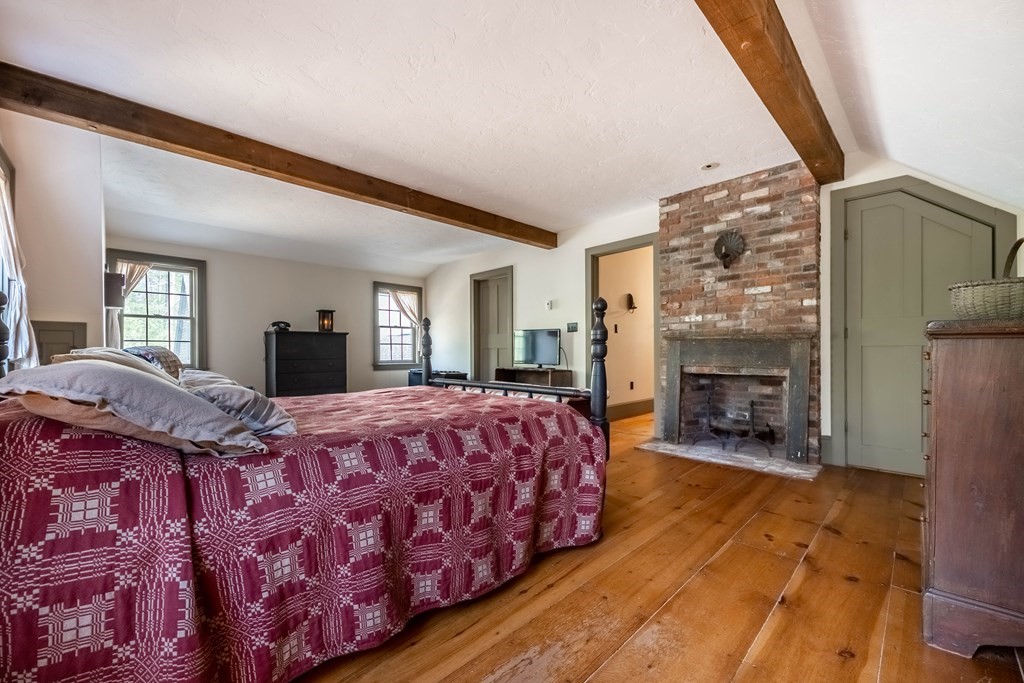 400 Main Street Boxford, MA 01921 - Photo 25 of 34 a spacious bedroom with a bed and a fireplace
