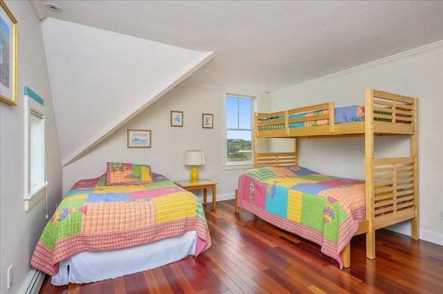 a bedroom with a bed and a wooden floor