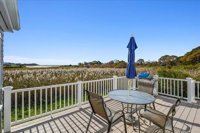 a view of a chairs and table on the deck