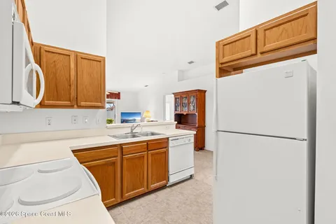 a utility room with sink dryer and washer