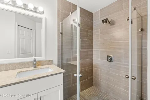 a bathroom with a granite countertop sink toilet and shower