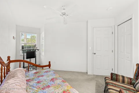 a bedroom with furniture and a window
