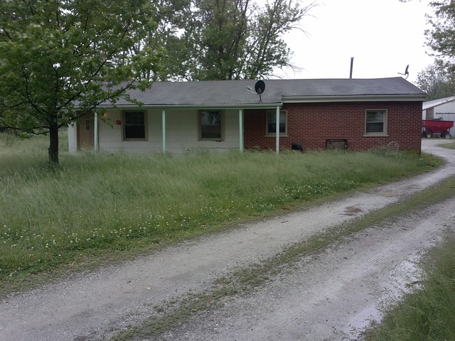 31556 South State Line Road Beecher, IL 60401 - Photo 1 of 25 a front view of a house with a garden