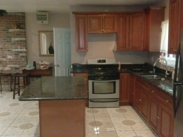 31556 South State Line Road Beecher, IL 60401 - Photo 14 of 25 a kitchen with kitchen island granite countertop a sink stove and cabinets