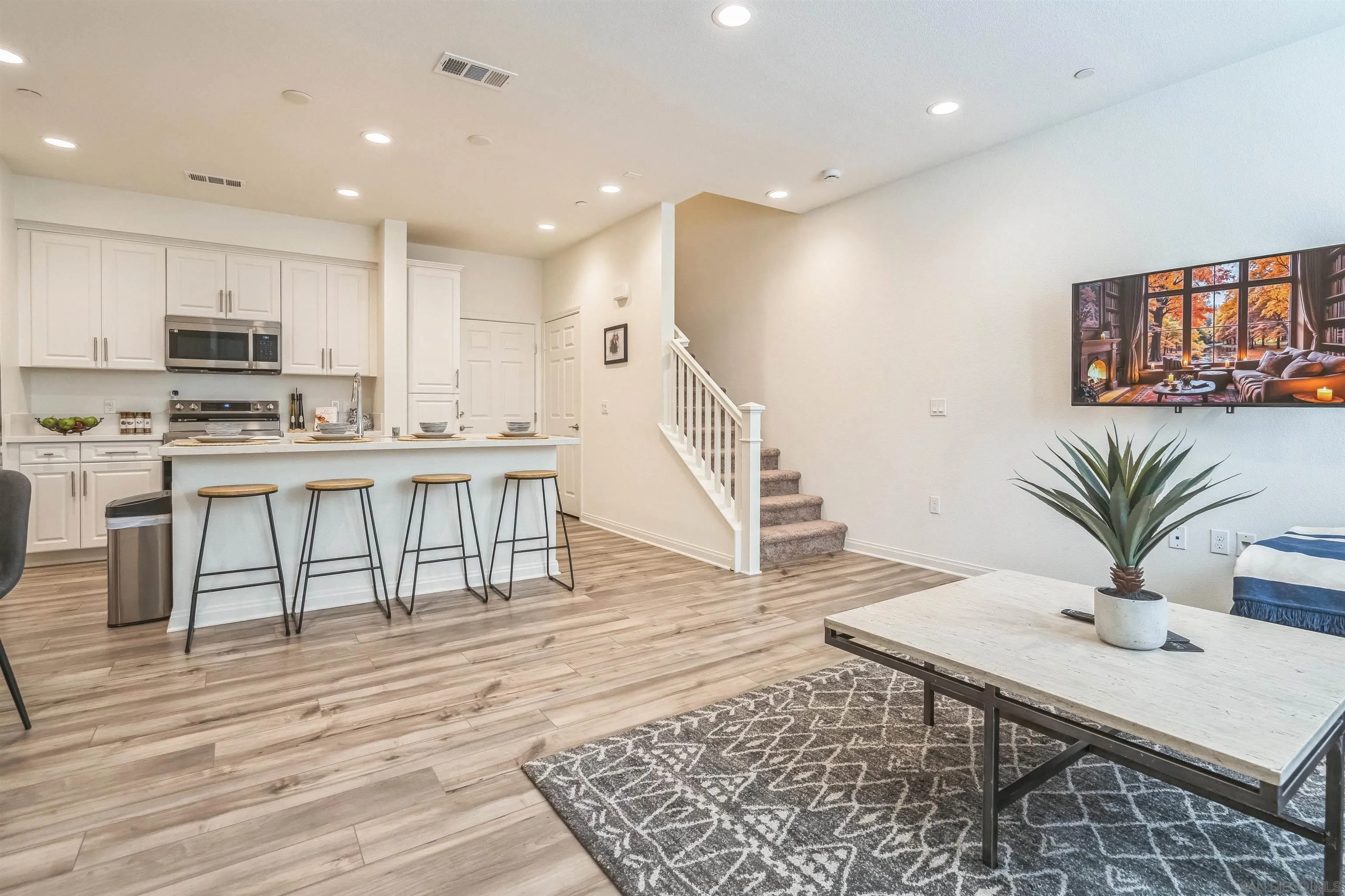 2018 Barite Street Spring Valley, CA 91977 - Photo 15 of 47 a living room with stainless steel appliances kitchen island granite countertop a sink and a wooden floor