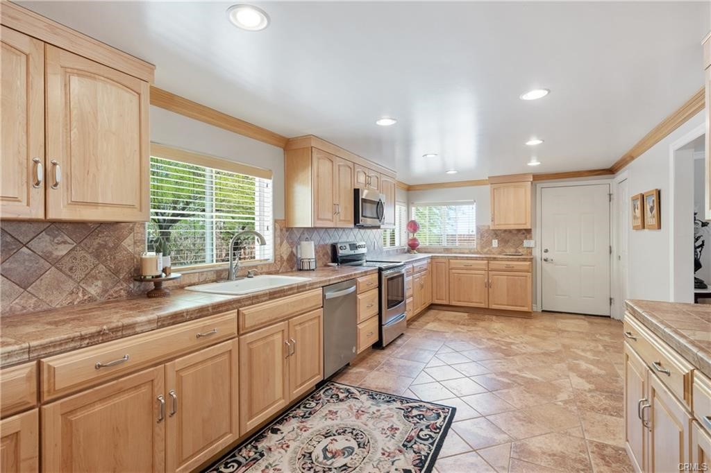 66125 Brant Cross Joshua Tree, CA 92252 - Photo 12 of 35 a kitchen with a sink window and cabinets