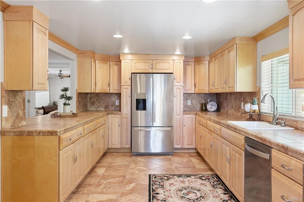 66125 Brant Cross Joshua Tree, CA 92252 - Photo 13 of 35 a kitchen with stainless steel appliances granite countertop a refrigerator sink and cabinets