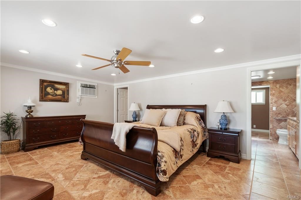 66125 Brant Cross Joshua Tree, CA 92252 - Photo 21 of 35 a bedroom with a bed and a chandelier