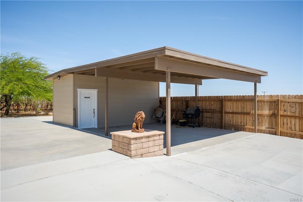 66125 Brant Cross Joshua Tree, CA 92252 - Photo 5 of 35 a view of a two chairs under an umbrella in patio