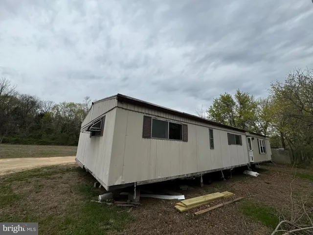 a view of a white house with a yard
