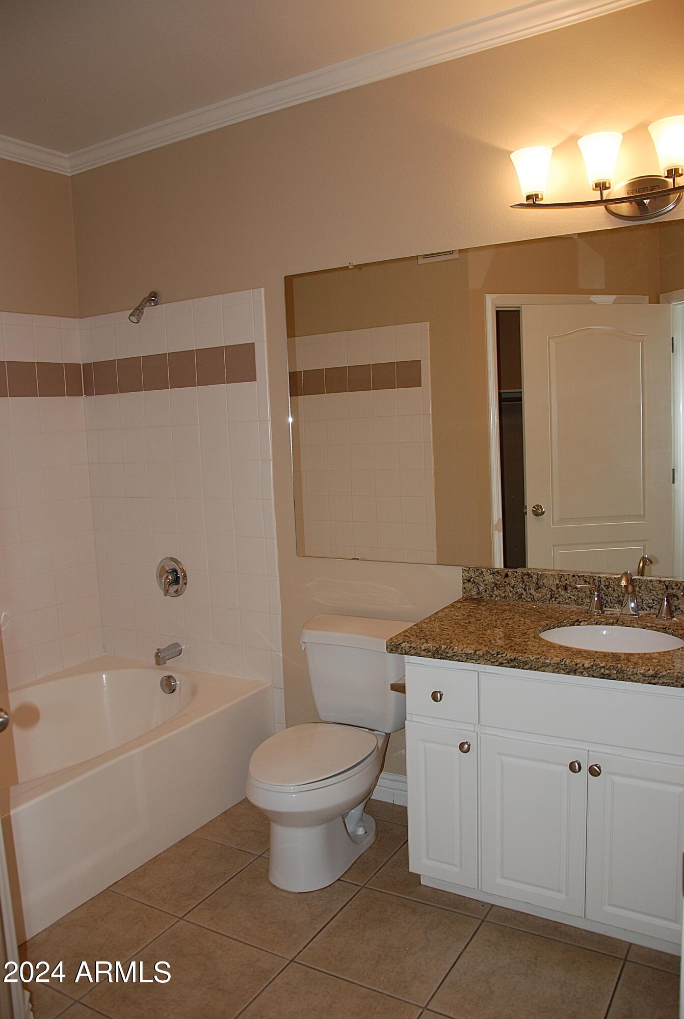 1701 East Colter Street, Unit 291 Phoenix, AZ 85016 - Photo 6 of 32 a bathroom with a granite countertop sink a toilet and bathtub