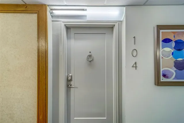 a bathroom with a painting on the wall and a shower