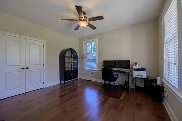 a workspace with wooden floor and a window