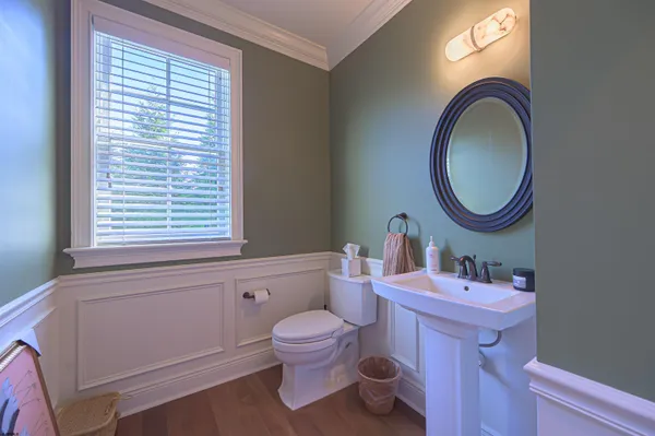 a bathroom with a toilet a sink and a mirror