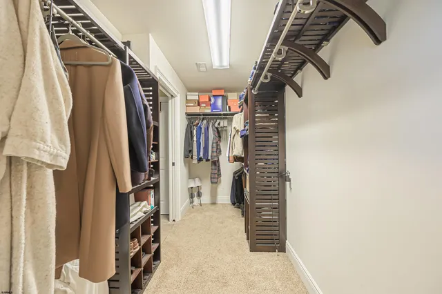 a view of walk in closet with clothes